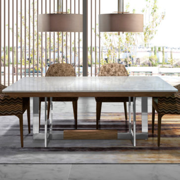 Modern Marble Top Dining Table The Modern Marble Top Dining Table stands as the centerpiece, its rectangular surface complemented by wooden elements. Cushioned chairs with patterned upholstery surround it, illuminated by two large pendant lights above. Tall windows in the backdrop reveal an inviting outdoor scene.
