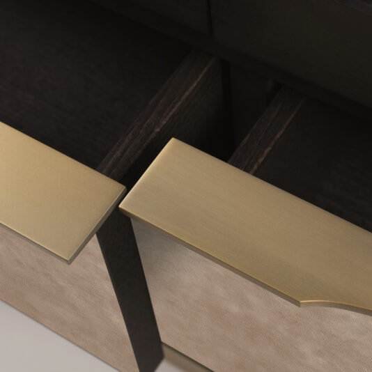 A close-up view of two slightly open drawers reveals gold metallic handles and light-colored front panels adorned with a textured pattern. These drawers, part of the Modern Wooden Dresser And Mirror Set, feature a dark interior finish that strikingly contrasts with the elegant exterior.