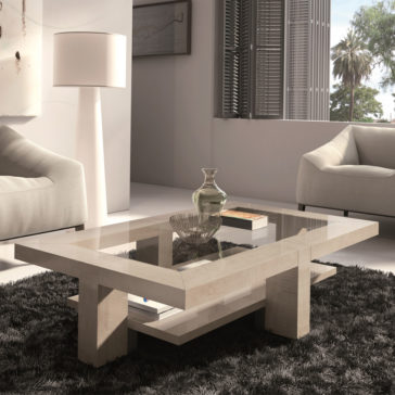 A modern living room features the Maple Veneer Rectangular Coffee Table With Glass Top, resting on a shaggy black rug. The table is decorated with a bowl and vase. Two beige armchairs flank the table, and a standing lamp illuminates the scene near a large window with shutters.