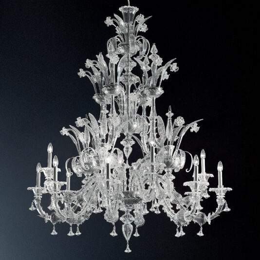 Suspended against a dark background, the Classic Glass Chandelier With Floral Detailing showcases multiple intricate glass arms adorned with delicate floral patterns. It holds several lit candle-shaped bulbs, creating a luxurious and elegant appearance.
