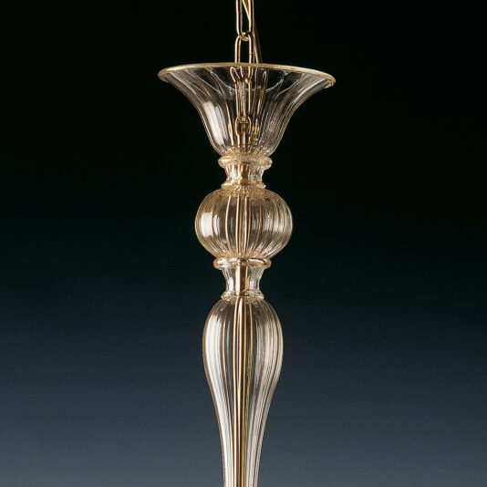 A close-up view of the Classic Gold Glass Ribbed Detail Chandelier, showcasing its intricately ribbed design and elegant gold accents. The ornate piece features a fluted top and a rounded middle section, gracefully suspended by a chain against a dark background.