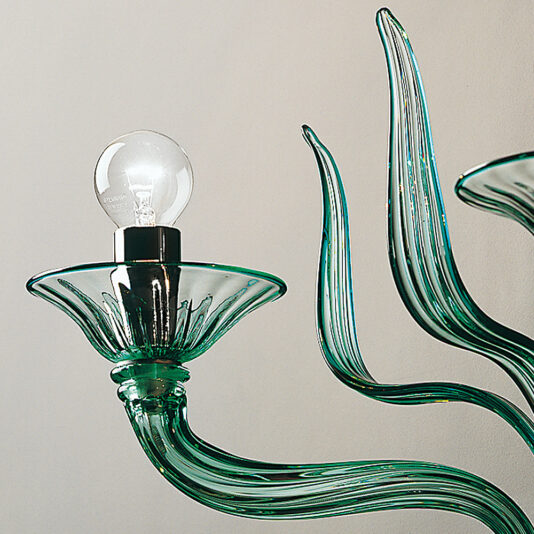 Classic Green Glass Ribbed Detail Wall Light A close-up image of the Classic Green Glass Ribbed Detail Wall Light with an exposed bulb. The ribbed detail enhances its artistic, wavy design, evoking organic, flowing shapes. The background is a plain off-white wall, allowing the elegant fixture to stand out beautifully.
