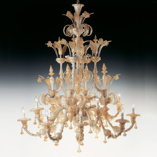 The Large Classic Murano Glass Chandelier features multiple tiers of intricate glasswork and candle-shaped bulbs. Adorned with elaborate floral and leaf designs, this ornate piece exudes luxury and elegance when set against a gradient background transitioning from white to black.