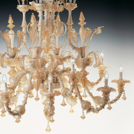 The Large Classic Murano Glass Chandelier is a detailed and ornate piece made of delicate Murano glass and gold. It features multiple arms with candle-like lights, exhibiting intricate designs and floral motifs that create an elegant and luxurious appearance against a gradient background.