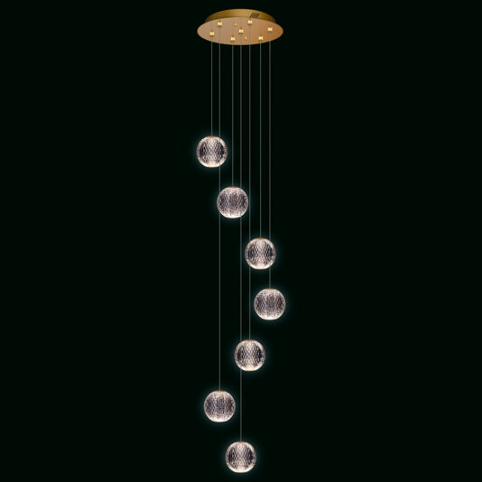 The Exclusive Set of 7 Pendant Lights forms a contemporary chandelier, with each globe-like light hanging in a cascading design from a round ceiling mount. The delicate net-like wire shades around the lights create a gentle glow against a dark setting.