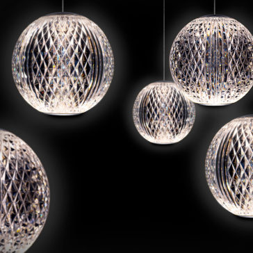 An Exclusive Set of 20 Pendant Lights, featuring intricate diamond-patterned glass shades, is artfully suspended against a black background. These spherical lights emit a soft, white glow, creating a sophisticated and elegant ambiance.