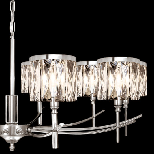 A close-up view showcases the High End 10 Arm Nickel Chandelier, adorned with multiple faceted glass shades mounted on a silver metallic frame. This sophisticated chandelier casts a warm, bright light against a black background.