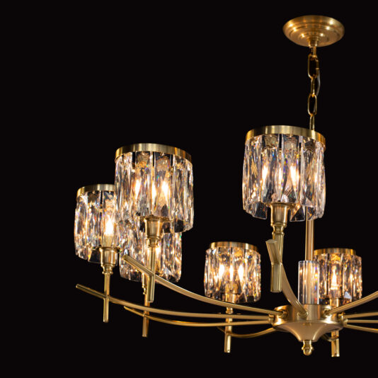 The High End 10 Arm Gold Chandelier features an elegant, modern design with ten intricately crafted arms supporting six light fixtures adorned with crystals. This gold-colored masterpiece emits a warm, inviting glow that beautifully illuminates the crystal details against a dark background.