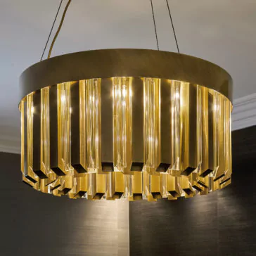 Luxurious Round Designer Chandelier The Luxurious Round Designer Chandelier showcases vertical, gold-toned metallic rods encasing several glowing light bulbs. Suspended from the ceiling by thin wires, it bathes a contemporary room in warm, luxurious light.