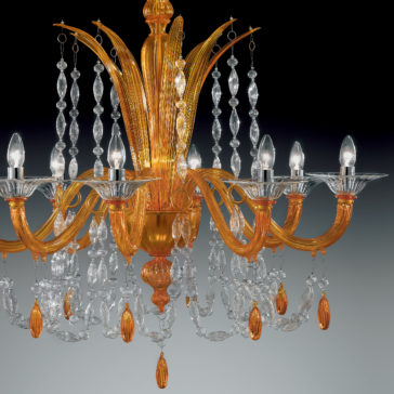 The Luxury Orange Crystal Drop Chandelier features golden curved arms adorned with multiple sparkling orange crystal droplets, each arm supporting a small lit bulb. This ornate chandelier boasts detailed glasswork and hanging crystal decorations, set against a gradient grey background.