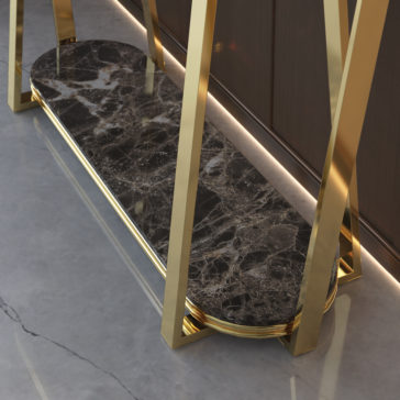 A sleek, modern Luxury Premium Marble Console Table featuring gold metal legs and a polished black top with white and gray veining, placed on a smooth gray floor against a dark wall. The design is minimalistic and luxurious, emphasizing the elegance of premium materials used.