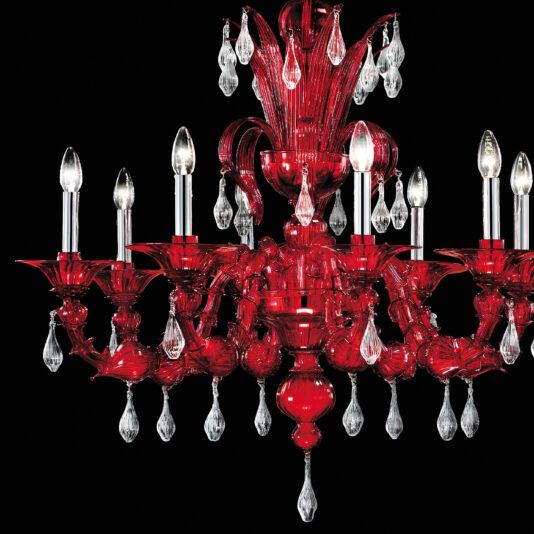 Opulent Red Crystal Drop Chandelier The Opulent Red Crystal Drop Chandelier showcases luxurious red glass with candle-like light bulbs. Its intricate designs are complemented by numerous clear glass teardrop pendants, arranged against a striking black background.