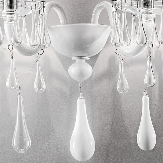 Classic Glass Teardrop Accent Wall Light A close-up of the Classic Glass Teardrop Accent Wall Light reveals an elegant, classic chandelier adorned with clear glass teardrop pendants. Featuring curved arms and a central bowl-shaped section, its minimalist design emphasizes the smooth surfaces and clean lines, making it a stunning accent wall light for any room.