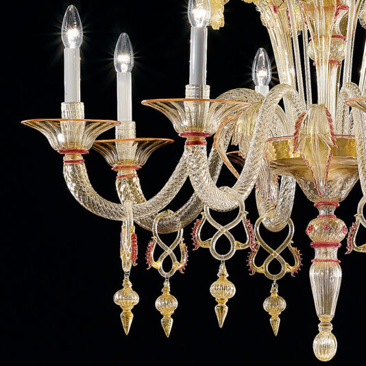 Classic Ornate Gold And Red Glass Chandelier A close-up of the Classic Ornate Gold And Red Glass Chandelier reveals intricately designed candle-like light bulbs. The chandelier showcases elaborate gold and red glass decorations with swirling patterns, accentuated by elegant hanging ornaments. The craftsmanship embodies luxury and sophistication.