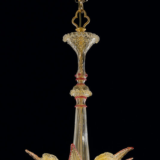 Classic Ornate Gold And Red Glass Chandelier A close-up of the Classic Ornate Gold And Red Glass Chandelier against a black background. The chandelier boasts delicate, intricate patterns with a vertical central structure and elaborate detailing, creating an elegant and sophisticated appearance.