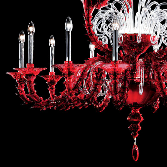 Classic Ornate Red Glass Chandelier The Classic Ornate Red Glass Chandelier showcases an exquisite design with intricate glasswork and elegant curved arms. Featuring multiple candle-like lights, its luxurious details stand out beautifully against a black background.
