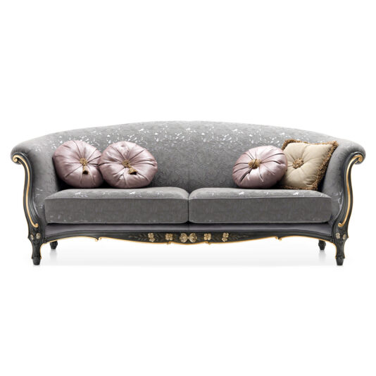 Classic Venetian Style Sofa The Classic Venetian Style Sofa is a luxurious, ornate piece in a gray shade, featuring an intricate floral design. It showcases elegant gold detailing and includes four decorative pillows: three circular mauve pillows and one beige, square pillow with gold trim, all arranged on the cushioned seats.