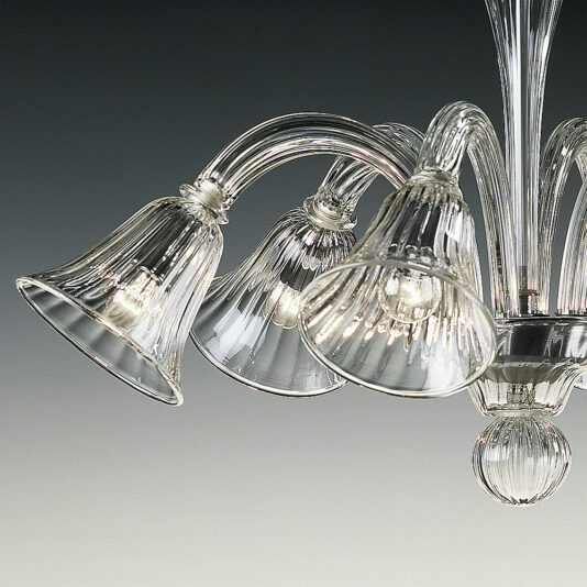 A close-up of the Clear Ribbed Detail Glass Chandelier showcasing its sophisticated design with multiple clear, ribbed glass bell-shaped shades. Curved glass arms radiate from a central point, supporting each shade while light reflects through the transparent glass to create an intricate and visually appealing display.