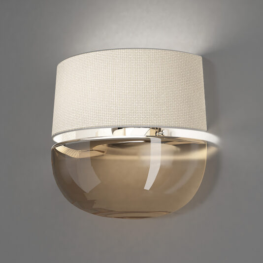 The Contemporary Dome Glass Wall Light boasts a beige, fabric-textured cylindrical lampshade paired with a glossy, translucent amber glass dome beneath it, all mounted on a sleek silver base. This modern wall sconce emits a subtle glow that accentuates its minimalistic design.