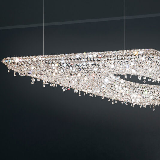 The Contemporary Suspended Crystal Pendant Chandelier is elegantly showcased against a dark background. Adorned with numerous small, sparkling crystals in a diamond-shaped design, it reflects light brilliantly, giving the space a dazzling and modern appearance.