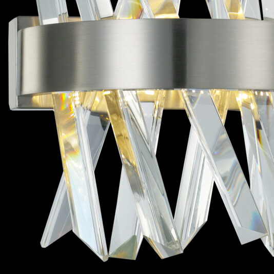 Exclusive Small Nickel Pendant Light Close-up of the Exclusive Small Nickel Pendant Light, showcasing a brushed metal band encircling multiple clear, prismatic glass rods. These rods are arranged in an angular, overlapping pattern and illuminated to cast intricate light reflections against a black background.