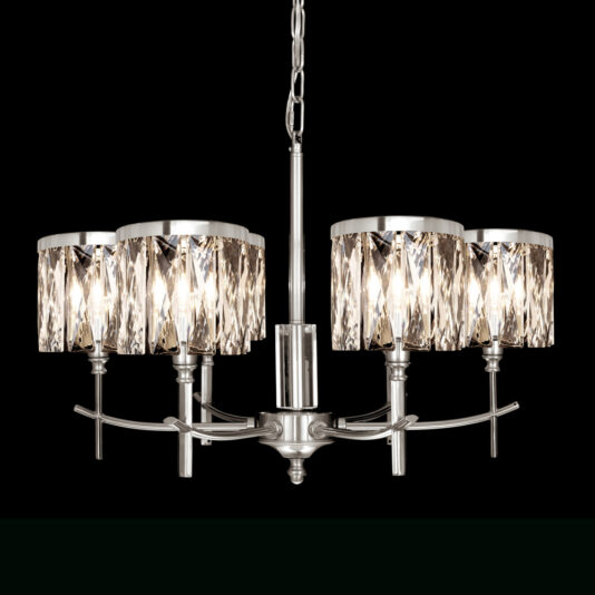 A modern chandelier with six lights, each encased in crystal-like cylindrical shades. The fixture is made of metal with a sleek, silver finish, and hangs from a chain against a black background. The lights are warmly lit, creating a sophisticated ambiance.