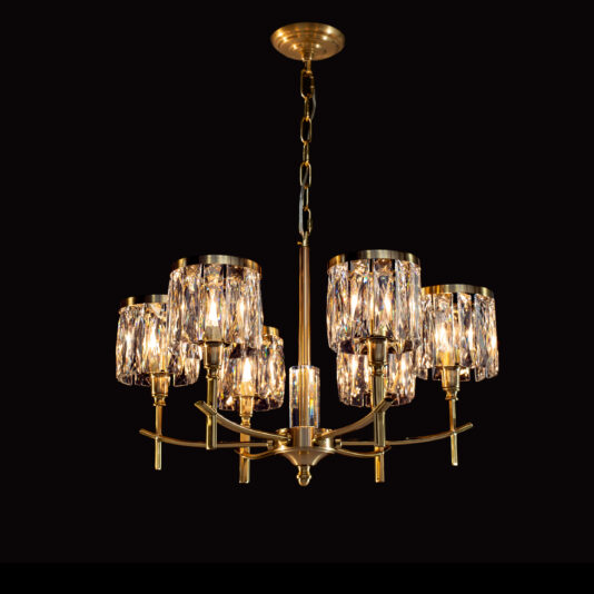 The High End 6 Arm Nickel Chandelier hangs against a black background, showcasing multiple arms extending from a central stem. Each arm holds a cylindrical, crystal-clear lampshade with a textured surface, emitting a warm, elegant glow.