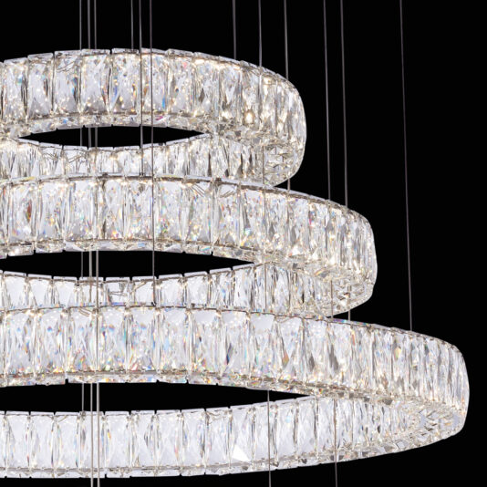 Luxury Five Ring Crystal Chandelier A detailed look at the Luxury Five Ring Crystal Chandelier showcases its large rectangular crystals. The chandelier boasts multiple concentric circular rings, each embellished with numerous reflective crystals, all elegantly suspended by thin wires against a black backdrop.
