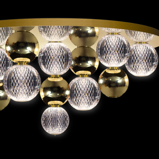 Luxury Gold Globe Ceiling Light The Luxury Gold Globe Ceiling Light is a modern chandelier showcasing an array of spherical lights with detailed, lattice-style designs and lustrous gold spheres. Mounted to a circular metallic base, this sophisticated lighting fixture stands out elegantly against a black background.