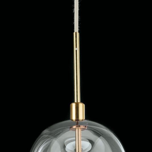 Contemporary Long Glass Dome Pendant Light A close-up of the Contemporary Long Glass Dome Pendant Light, featuring a gold-colored stem and a clear glass shade. The fixture is suspended against a black background, showcasing its sleek and modern design.