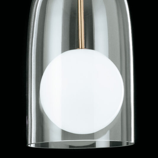 Contemporary Long Glass Dome Pendant Light Close-up of the Contemporary Long Glass Dome Pendant Light, featuring an inverted transparent dome encasing a white, spherical bulb. The fixture appears suspended, showcasing a sleek and modern design against a black background.