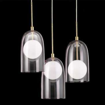Contemporary Long Glass Dome Pendant Light A photo showcasing three Contemporary Long Glass Dome Pendant Lights, each with a clear glass dome and hanging from thin metallic rods. Each pendant light contains a central white spherical bulb and is set against a black background, thoughtfully arranged at varying heights.