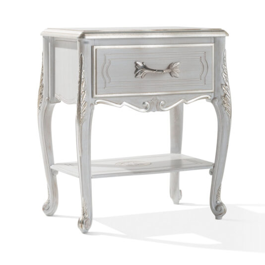 The Ornate Bedside Cabinet With Drawer is a vintage-style nightstand that showcases a distressed white finish. It features an elegant drawer with an ornate handle and decorative floral carvings. The table boasts curved legs with detailed carvings and an open lower shelf for added charm.