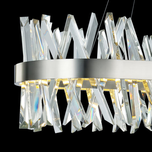 Oval Crystal And Nickel Chandelier A close-up of an elegant chandelier featuring rectangular, crystal-like prisms arranged in a striking, crisscross pattern. The prisms are attached to a sleek, metallic ring, and the lighting creates a shimmering effect against the dark background.