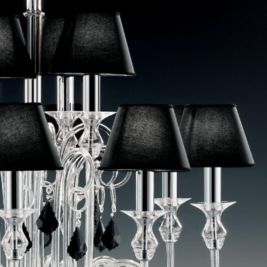Traditional Chandelier With Black Crystal Drops A detailed image of the Traditional Chandelier With Black Crystal Drops, showcasing its multiple clear glass arms and hanging black crystal drops. Each candle-style light is topped with a thin, sleek black lampshade, all set against a dark background.