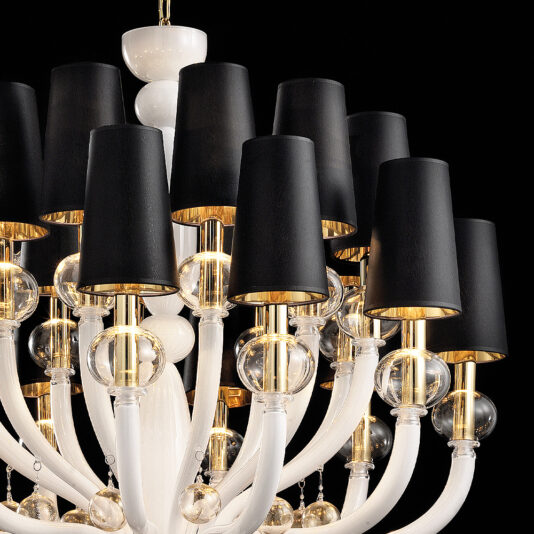 Traditional Glass Orb Detail Chandelier The Traditional Glass Orb Detail Chandelier boasts a white and gold color scheme, with multiple gracefully curved arms adorned by small glass orbs and elegant black lampshades. These glass orb details enhance its sophisticated design, making it stand out beautifully against a dark background.