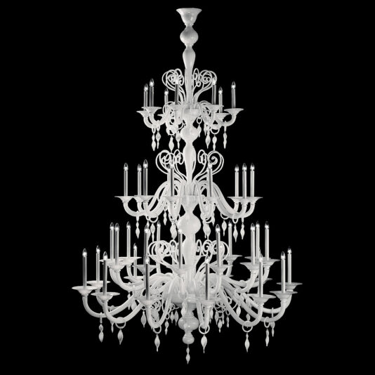 The Traditional Three-Tier White Glass Chandelier is an ornate lighting fixture with multiple levels, featuring numerous intricate arms that hold candle-style lights. Its design boasts elegant, curved details and hanging crystal ornaments, all set against a black background.