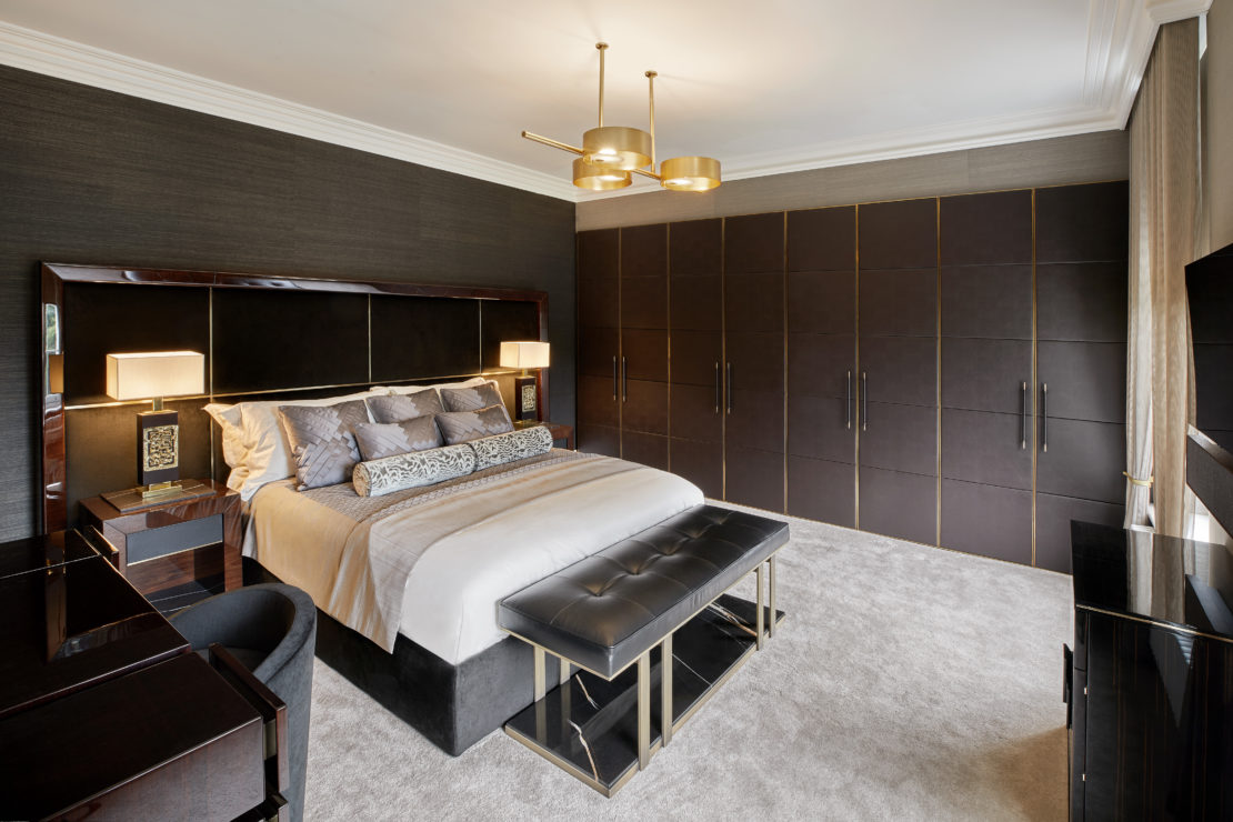 Gentleman's pad bedroom with large bed, headboard and luxury furnishings