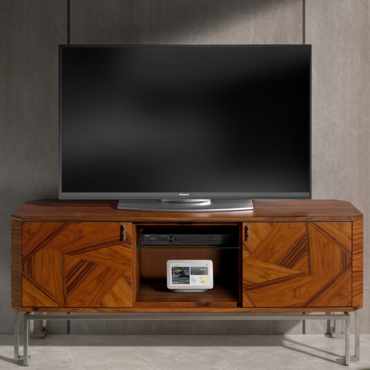 An *Elegant Contemporary Veneer TV Unit* holds a flat-screen television. The unit features wooden cabinets with geometric patterns and metal legs. One cabinet door is open, revealing a small electronic device with a screen. The background is a minimalist stone wall, complementing the sleek design of the TV stand.