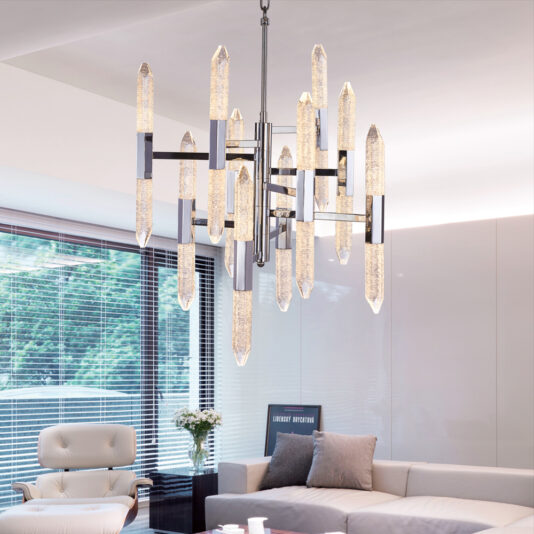 Exclusive Chandelier With Vertical Crystals A modern living room adorned with the Exclusive Chandelier With Vertical Crystals hanging from the ceiling. The space boasts a neutral color palette with white and beige furniture, including a cushioned armchair and a sectional sofa.