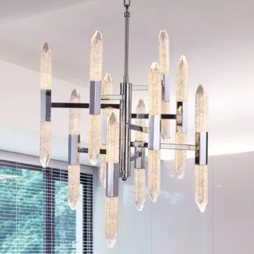 Exclusive Chandelier With Vertical Crystals The Exclusive Chandelier With Vertical Crystals boasts a modern design, featuring elongated textured glass pendants and stunning vertical crystals arranged in an intricate geometric pattern. Metal accents and a central rod support the chandelier, making it the perfect addition to a room with white walls and large windows with partially open blinds.