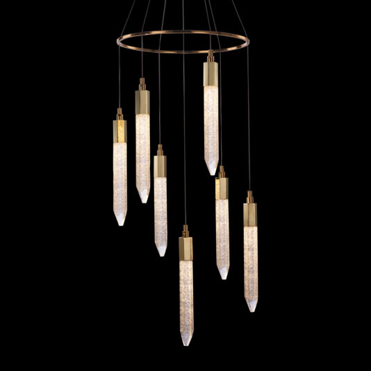 The Exclusive Gold Pendant Light Cluster is a modern chandelier featuring seven elongated, cylindrical lights with sparkling interiors, suspended at varying heights from a circular gold frame against a black background. Each light boasts a tapered, crystal-like design at the bottom.