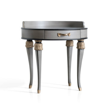 Exclusive Side Table With Tassel Design Detail Introducing the Exclusive Side Table With Tassel Design Detail, a stylish and elegant addition to your interior decor. This round gray piece features four decorative tapered legs with gold accents and a single central drawer adorned with a gold handle. Its elevated back edge adds a touch of sophistication, beautifully blending modern and classic design elements.