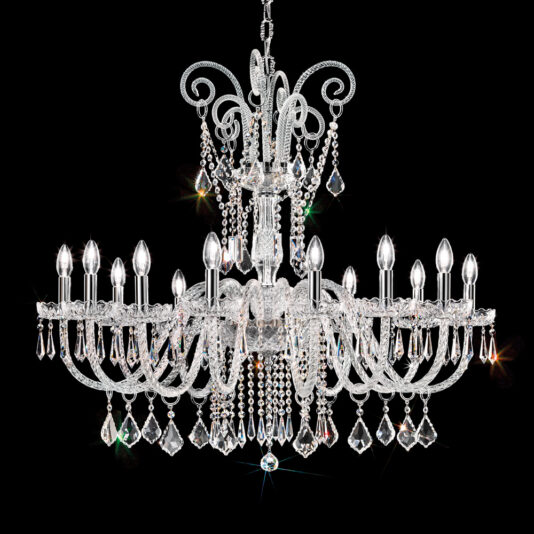 The Large Blown Glass Chandelier With Crystal Drops, featuring numerous candle-shaped bulbs and ornate detailing, hangs against a black background. Its multiple tiers of sparkling crystal drops and elegant, curved arms reflect light to create a dazzling effect.