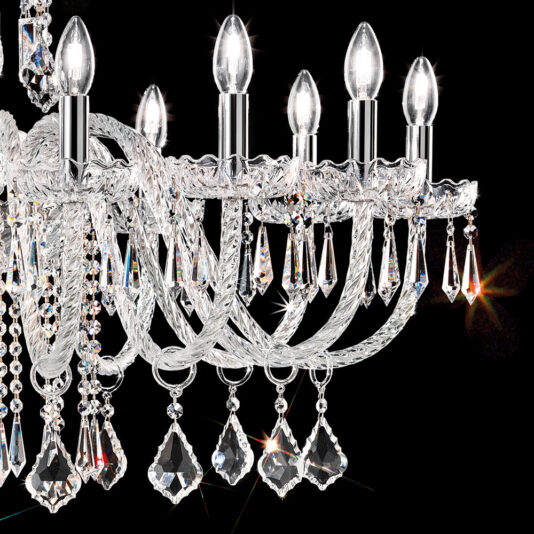 Large Blown Glass Chandelier With Crystal Drops A close-up view of the Large Blown Glass Chandelier With Crystal Drops against a black background. This luxurious chandelier features intricate, curved arms adorned with multiple sparkling crystal drops and lit candle-shaped bulbs, casting a bright and elegant light.