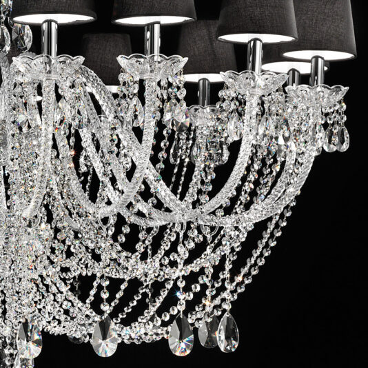 Large Crystal Chandelier With Shades A close-up of the Large Crystal Chandelier With Shades highlights its black lampshades and elegant design. The chandelier features ornate, dangling crystal strands and teardrop-shaped crystal ornaments that catch the light, creating a sparkling effect against a dark background.