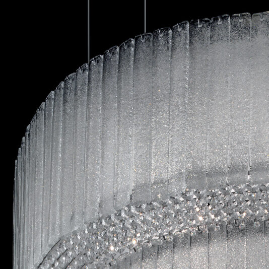 Large Modern Tiered Glass Chandelier Close-up of the Large Modern Tiered Glass Chandelier, showcasing its sleek design with vertical ridges and a textured, translucent surface. The chandelier's intricate details are highlighted against a black background, featuring a ring of small, sparkling lights inside.