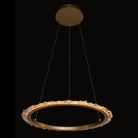 The Large Quartz Crystal Gold Round Chandelier is a modern fixture suspended from the ceiling by thin wires, boasting a gold frame adorned with large quartz crystal accents around its perimeter, set against a black background.