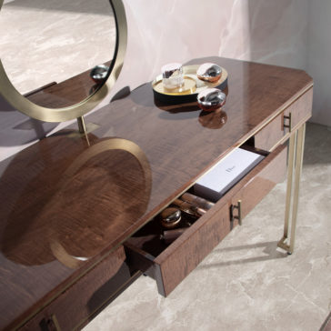 Introducing the Luxury Brown Maple Veneer Vanity Table: a sophisticated piece featuring a sleek brown maple veneer surface, two open drawers with organized compartments, and a round mirror adorned with a gold frame. A round gold tray elegantly holds bottles on the right side, while the table stands gracefully on gold metal legs.