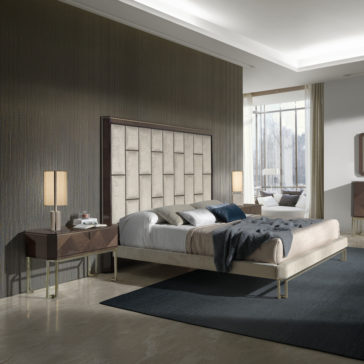Luxury Velvet Fabric Upholstered Bed A contemporary, opulent bedroom showcases the Luxury Velvet Fabric Upholstered Bed with a stylish oversized geometric headboard. The bed is flanked by nightstands with lamps, while large windows illuminate the space with natural light. The minimalist decor in neutral tones is complemented by a plush area rug.